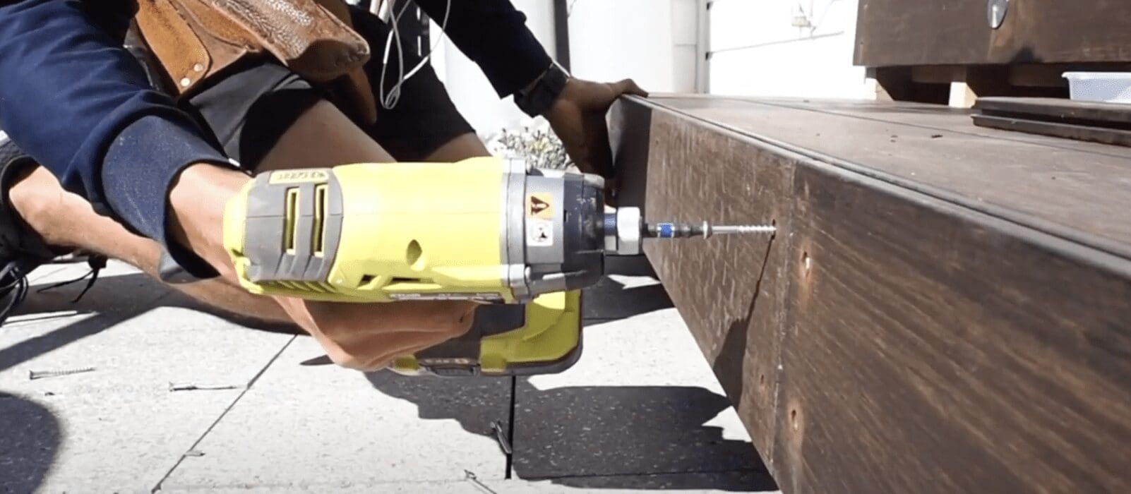 Man screwing bamboo decking together with a drill